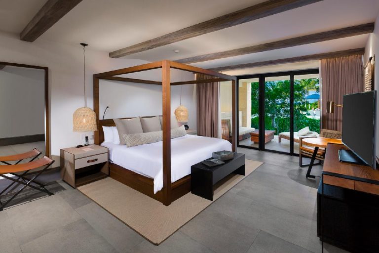 Main bedroom area of an Estancia Suite with a tropical view.