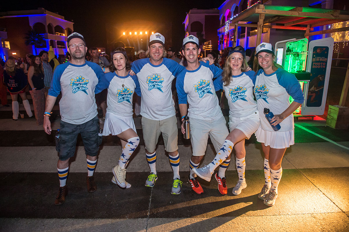 Group photo of guests in matching theme night outfits.