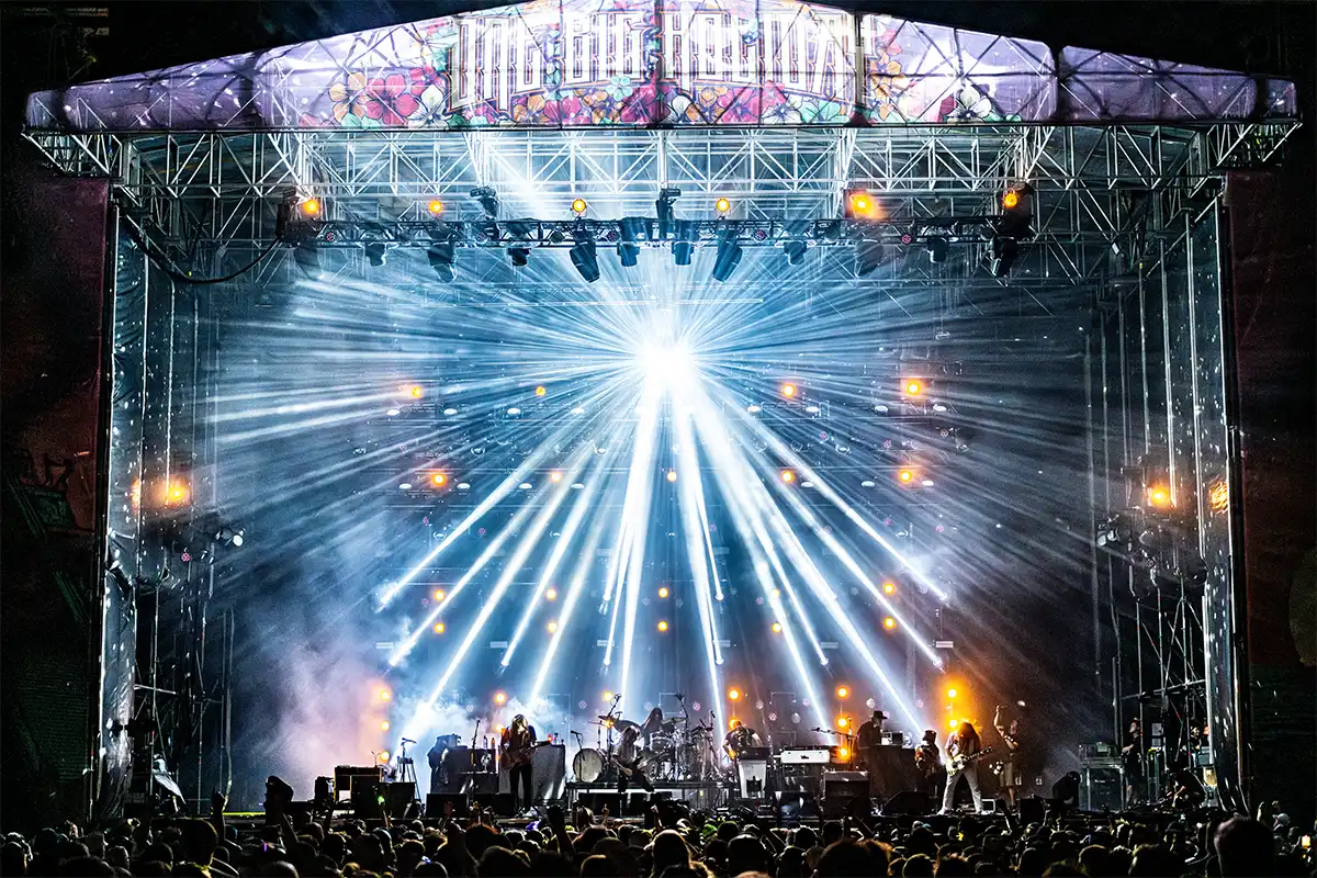 The Concert Courtyard Main Stage at night, a bright disco ball shines light across the stage.