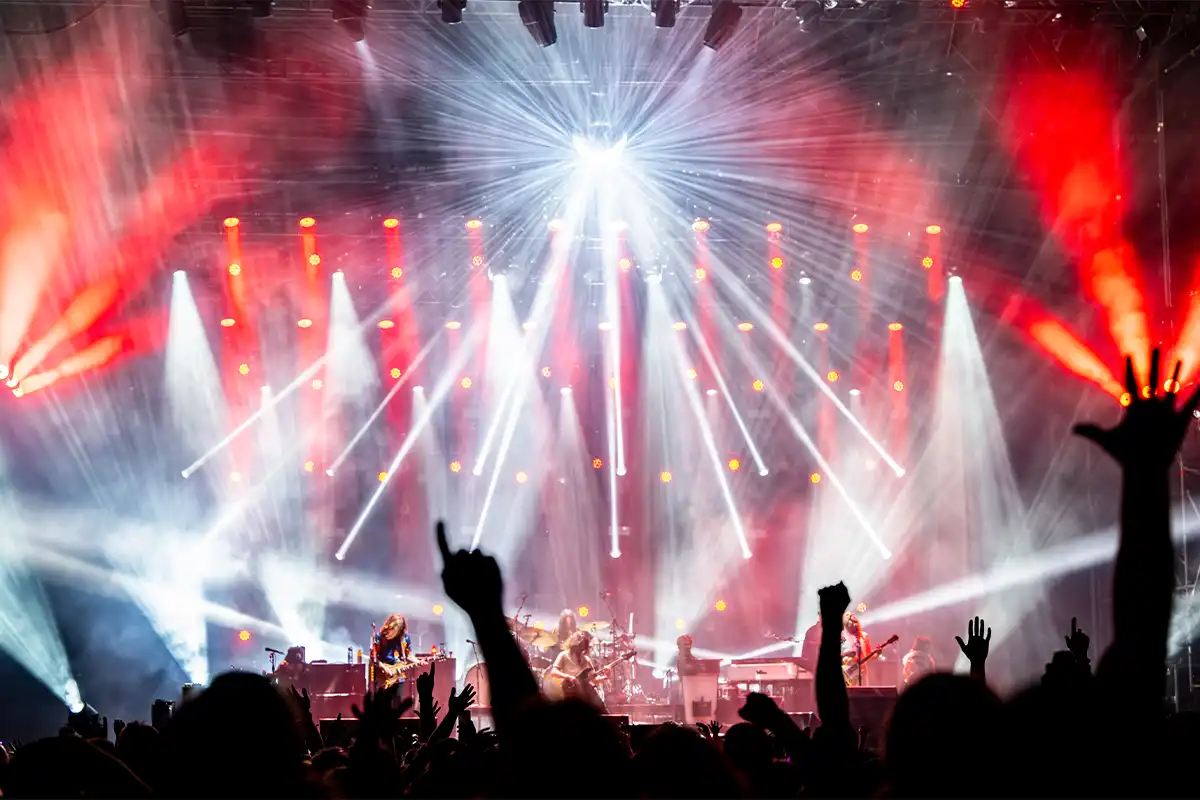 View from the crowd of My Morning Jacket, guests with their hands up in view.