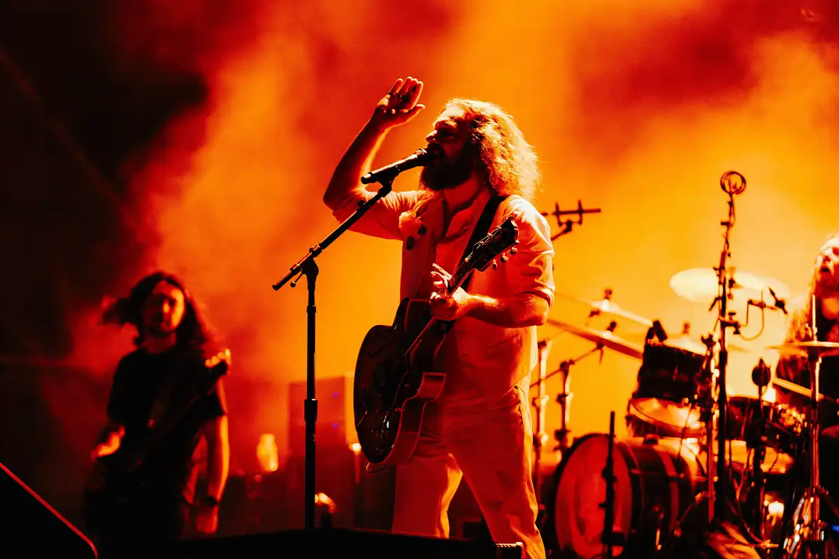 A close up of Jim James of My Morning Jacket singing.