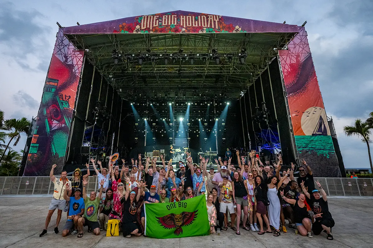 A One Big Family meetup group photo in front of the Main Stage.
