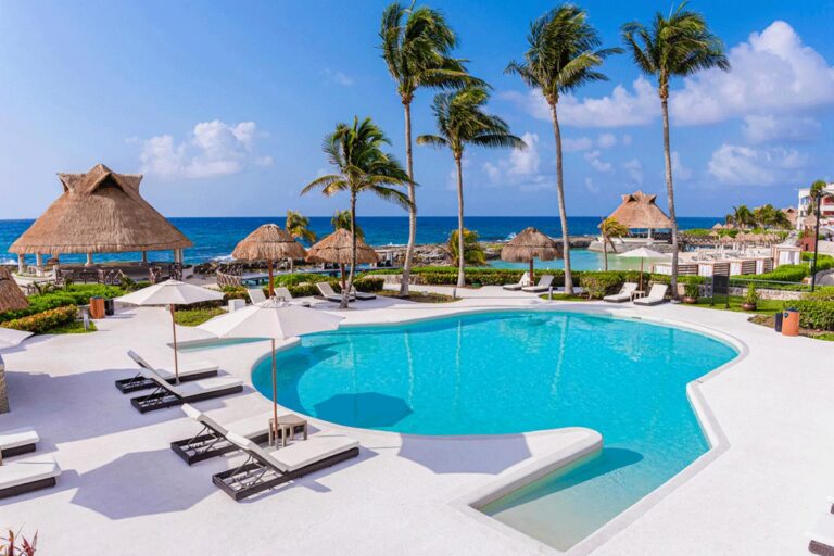 Pool chairs lined up next to a pool.